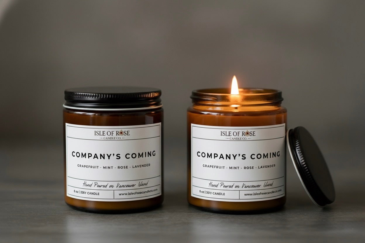 Two candles from Isle of Rose on a gray background, one lit and one unlit.