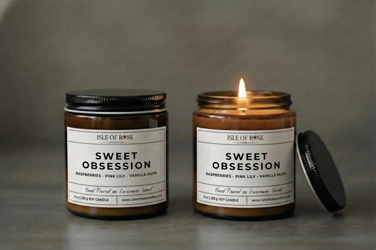 Two candles labeled 'Sweet Obsession' by Isle of Rose on a gray background