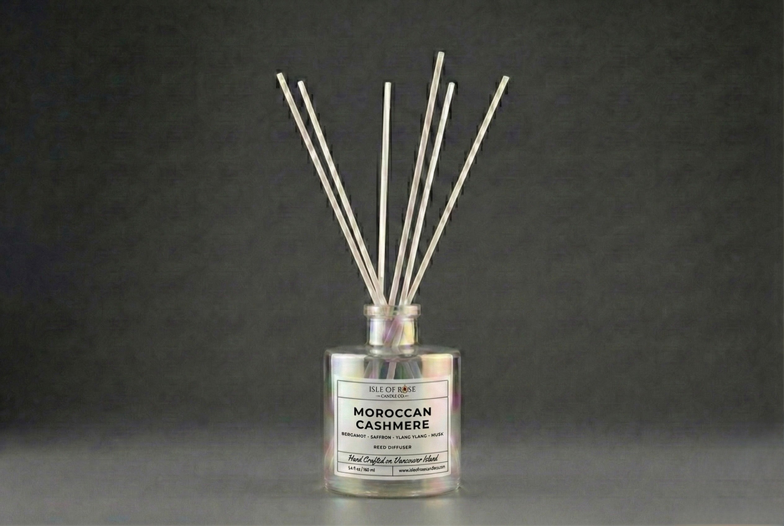 Reed diffuser labeled 'Moroccan Cashmere' on a dark background