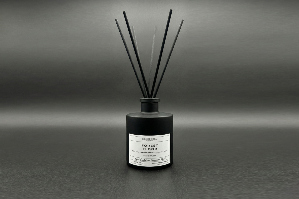 Black diffuser bottle labeled 'Forest Floor' on a gray background