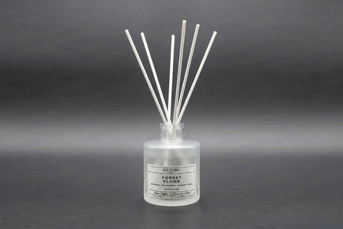 Reed diffuser labeled 'Forest Floor' on a gray background