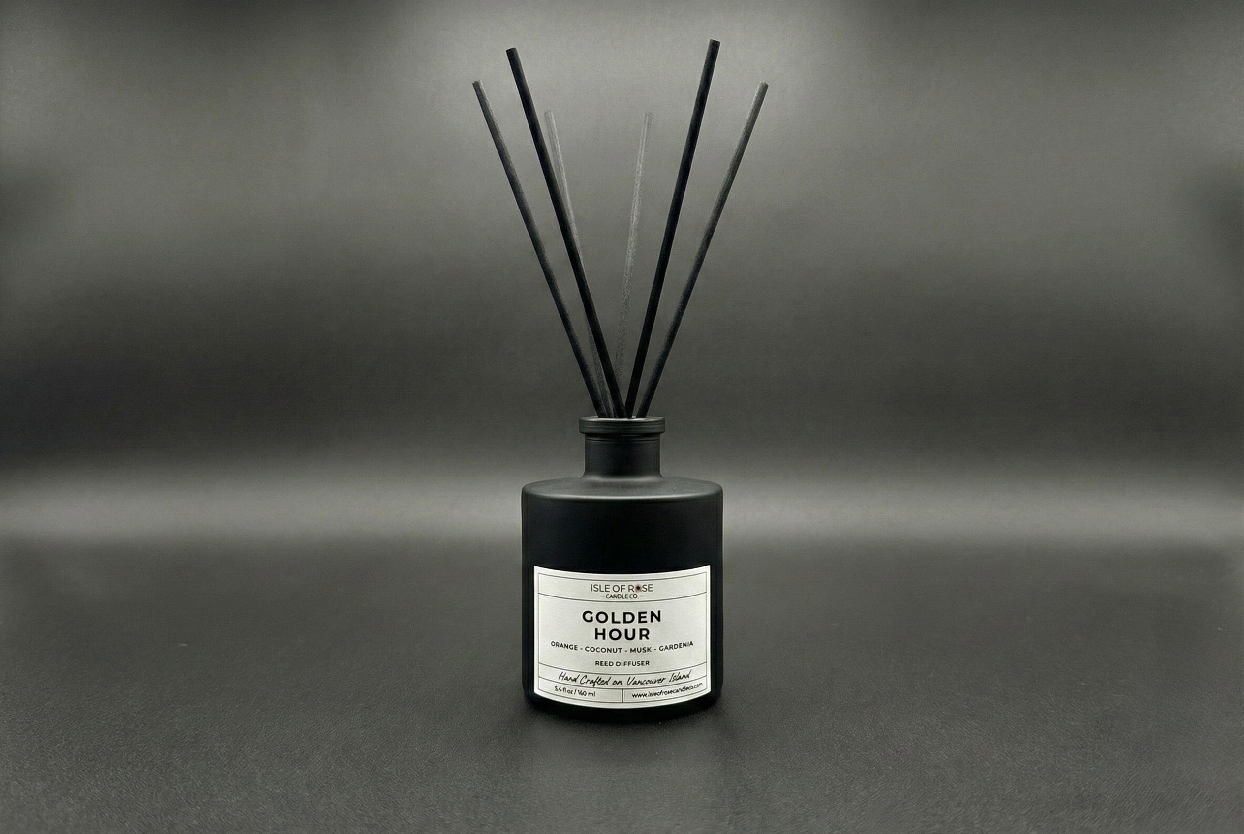 Black diffuser bottle labeled 'Golden Hour' on a gray background