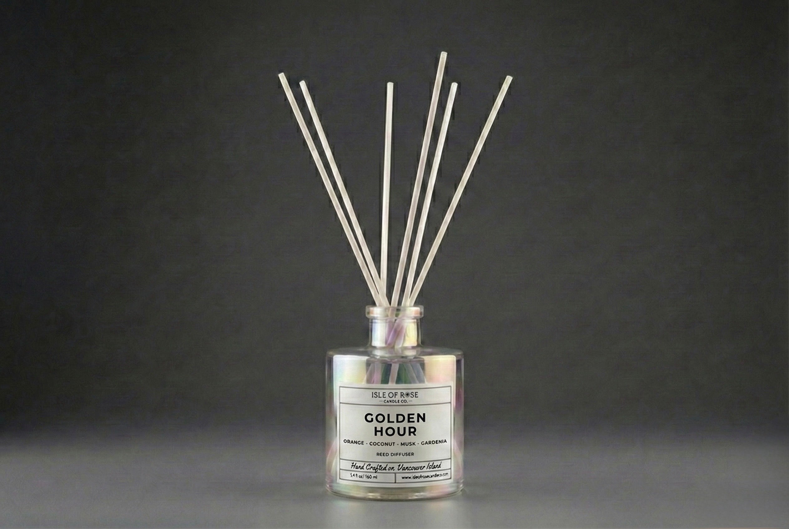 Diffuser with reeds labeled 'Golden Hour' on a dark background