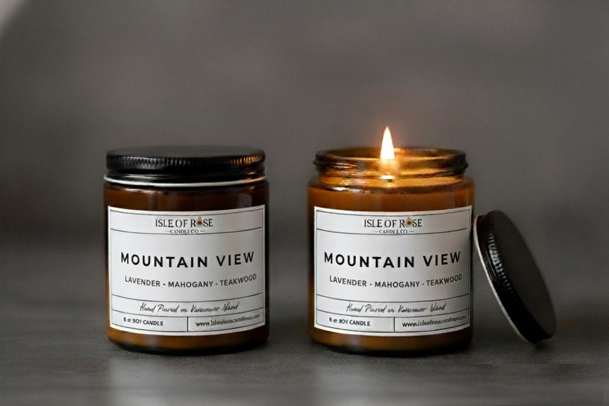 Two 'Isle of Rose' Mountain View candles on a gray background