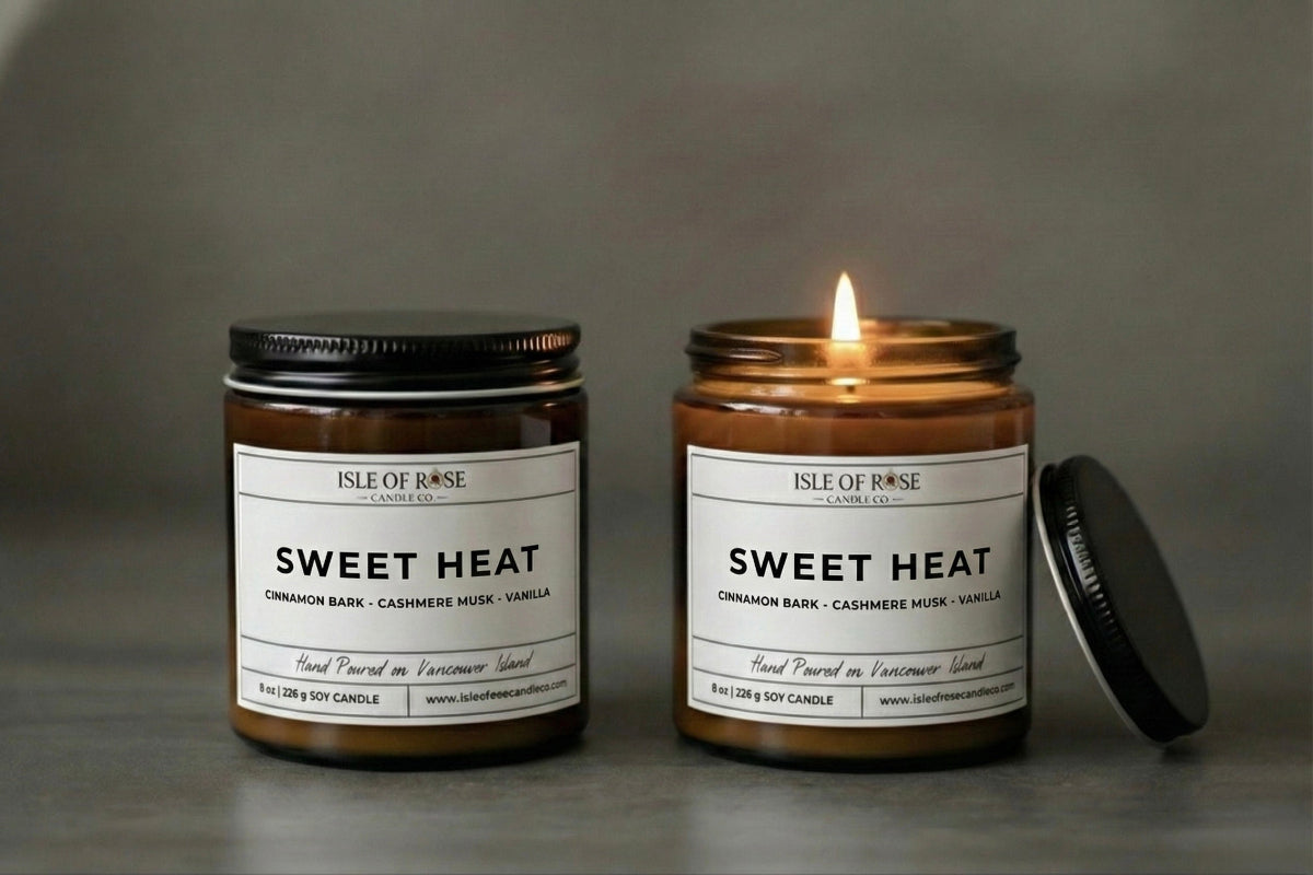 Two candles labeled 'Sweet Heat' by Isle of Rose on a gray background